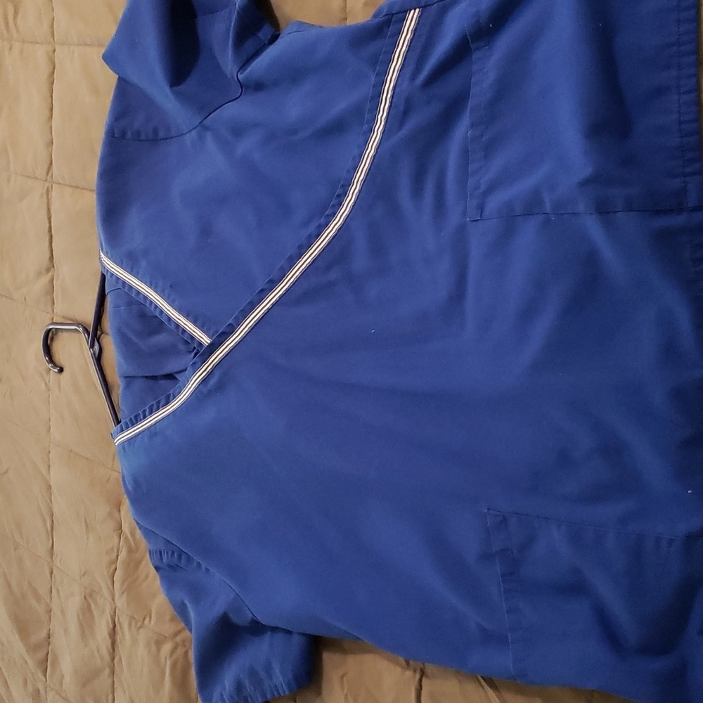 BLUE SCRUB with white stripes across the chest size Large